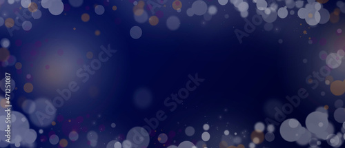 Blue Christmas festive background. Defocused highlights. Bokeh. Light and rays are blurry. Merry Christmas