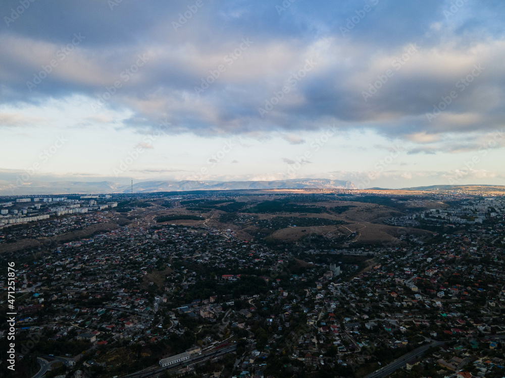 Beautiful storm clouds over the city. Panorama from above.