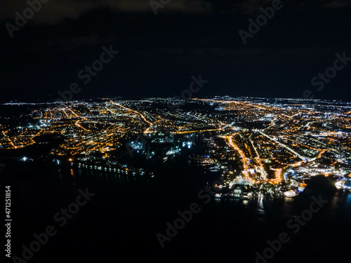 Lights of the embankment of a night seaside city from a great height.