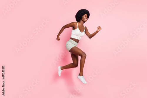 Full length body size photo girl smiling jumping high running fast on sale isolated pastel pink color background