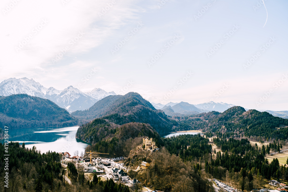 Hohenschwangau Castle in the forest among the mountains. Panorama