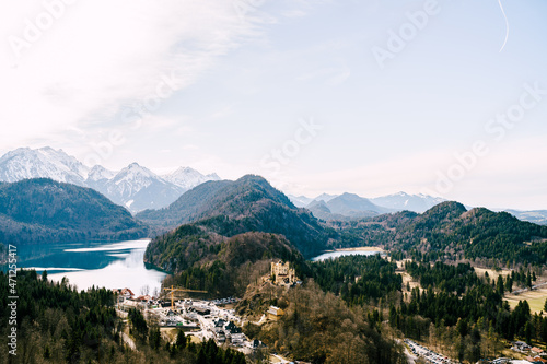 Hohenschwangau Castle in the forest among the mountains. Panorama