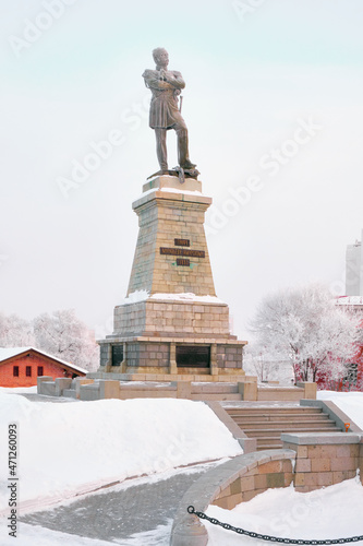 Monument to General Governor-General of Eastern Siberia Nikolai Nikolaevich Muravyov-Amursky in Khabarovsk in the morning at sunrise. There are trees in the snow all around.