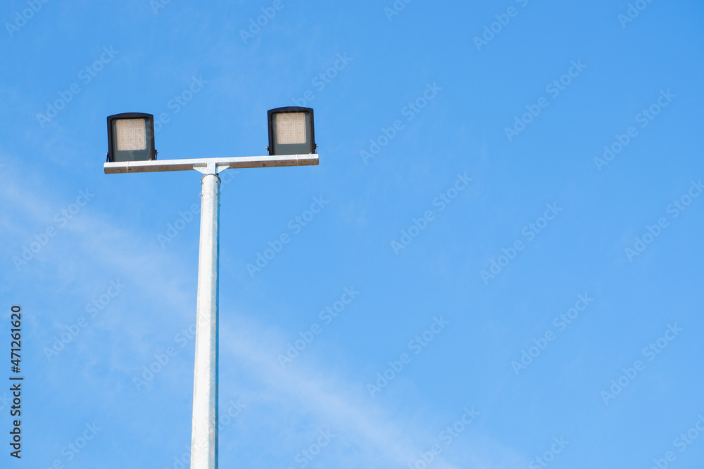 Modern park LED luminaire on a tall metal mast.