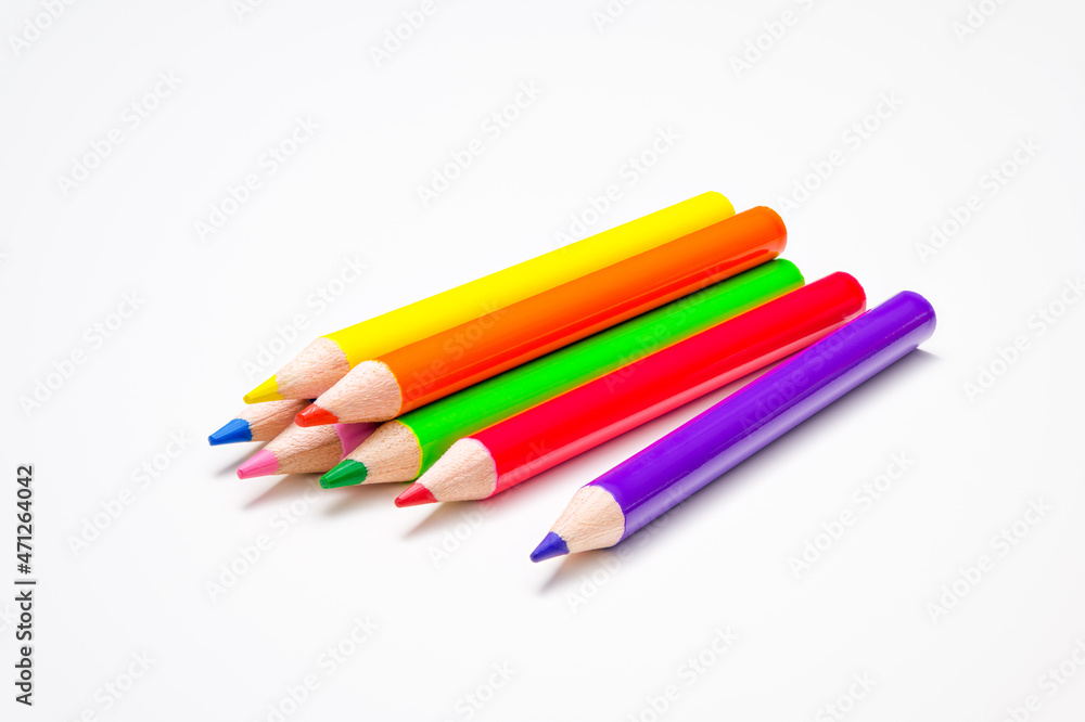 Childhood, back to school, education, creativity. Seven pens in bright rainbow colors on a white desk background Childhood, back to school, education, creativity. Seven pens in bright rainbow colors on a white desk background