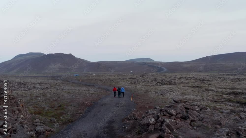 Aerial view of tourist hikers discovering exploring Iceland countryside. Drone view four people tourist mountaineering hiking in icelandic nordic highlands Aerial view of tourist hikers discovering exploring Iceland countryside. Drone view four people tourist mountaineering hiking in icelandic nordic highlands