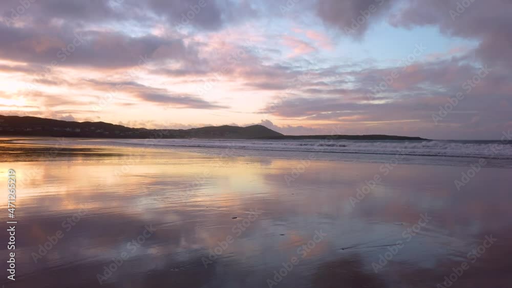 Dramatic sunset and waves at Narin Strand by Portnoo, County Donegal in Ireland. Dramatic sunset and waves at Narin Strand by Portnoo, County Donegal in Ireland.