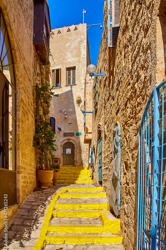 Fototapeta Naklejka Na Ścianę i Meble -  atmosphere of antiquity in one of streets of old Jaffa. The streets are narrow, the stones are worn to shine. impression is that you are transported to Middle Ages