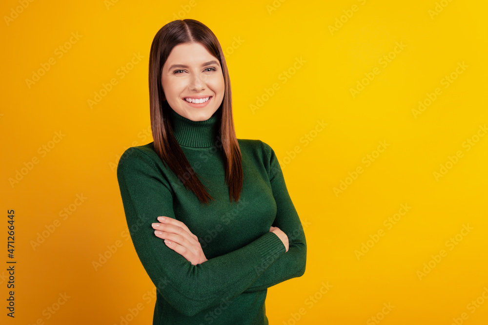 Photo of cheerful glad proud lady crossed arms beaming smile wear green shirt isolated on yellow background Photo of cheerful glad proud lady crossed arms beaming smile wear green shirt isolated on yellow background