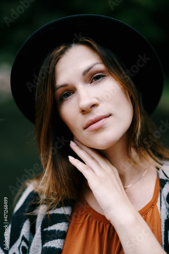 Woman with long hair wearing a hat. Portrait