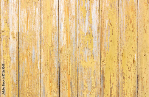Old grey and yellow wooden background with cracks and scratches in vintage style