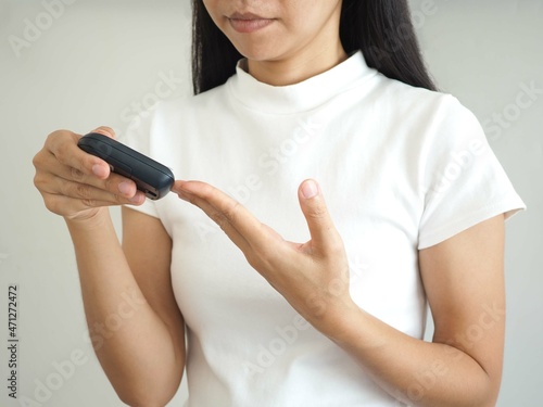 Woman hands checking blood sugar level by glucose meter using as medicine, diabetes, glycemia, health care concept. closeup photo, blurred.