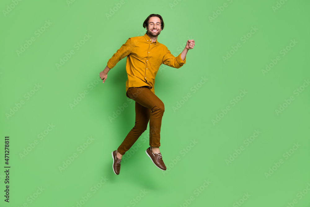 Full size profile photo of cute young guy run wear smart casual eyewear shirt pants shoes isolated on green background