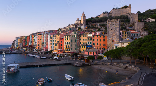 Evening landscape of picturesque Italian town of Portovenere with fortress walls on Ligurian seaside, Italy