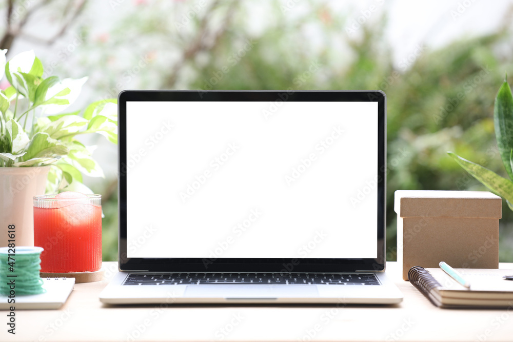 laptop mock up white blank screen with gift box and juice on wooden desk laptop mock up white blank screen with gift box and juice on wooden desk
