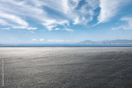 Asphalt road and sea scenery, road and sky background. © ABCDstock