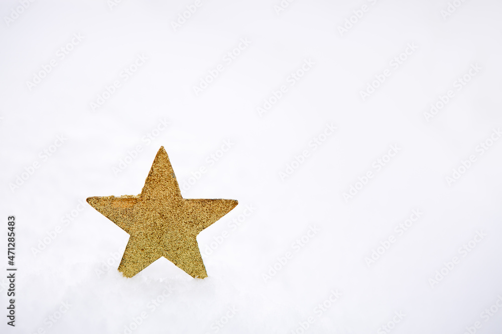 Fototapeta premium Christmas background with yellow star on white snow.