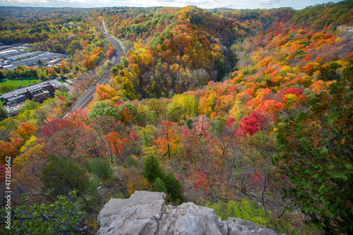 Beautiful Fall colours views of the Spencer Gorge along the Dundas Peak trail in Hamilton, Ontario, Canada. Train tracks are visible from the lookout.