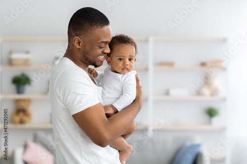 Daddy's Love. Happy Black Young Man Embracing His Cute Infant Son