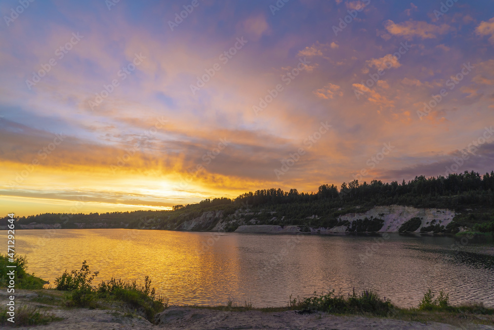 Sunset in the cloudy sky over the Pugorevsky quarry. Vsevolozhsk. Leningrad region