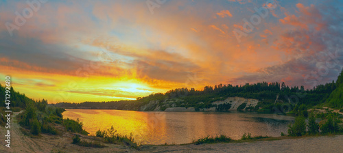 Sunset in the cloudy sky over the Pugorevsky quarry. Vsevolozhsk. Leningrad region