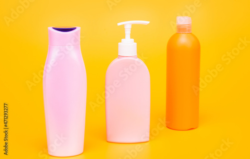 Shampoo, conditioner and lotion liquid toiletry product containers in row, bottles