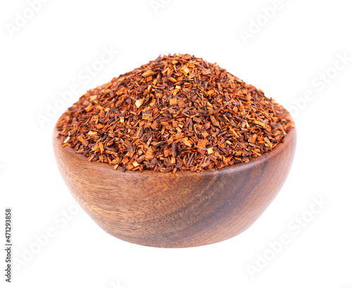 Rooibos red tea in wooden bowl, isolated on white background. Traditional herbal and organic tea.