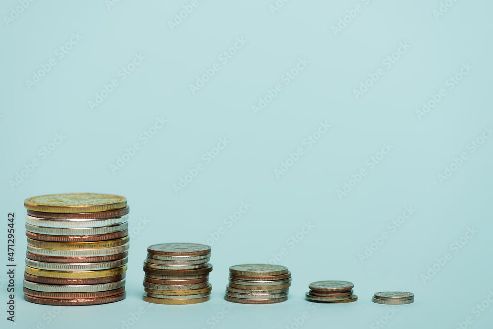 stacks of golden and silver coins on blue background with copy space, anti-corruption concept stacks of golden and silver coins on blue background with copy space, anti-corruption concept