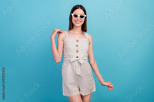 Photo of funny tender lady touch sensual shoulder wear sunglass dotted overall isolated blue color background