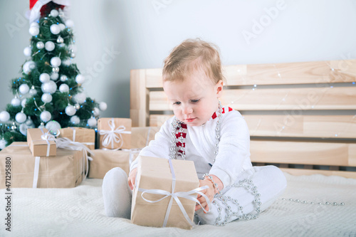 Baby dressed like snowman with Christmas gifts...