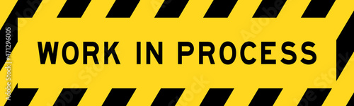 Yellow and black color with line striped label banner with word work in process