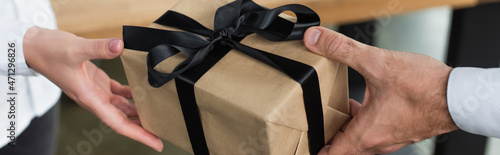 Fotografie partial view of businesswoman taking present from man, anti-corruption concept,