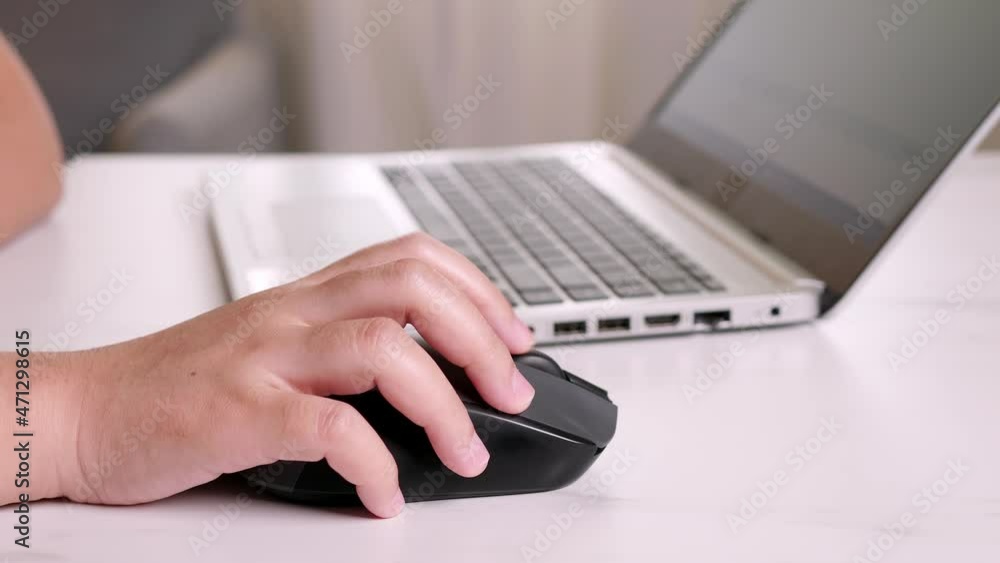 Close up of woman use of computer with mouse. Businesswoman hand using mouse working on notebook Close up of woman use of computer with mouse. Businesswoman hand using mouse working on notebook