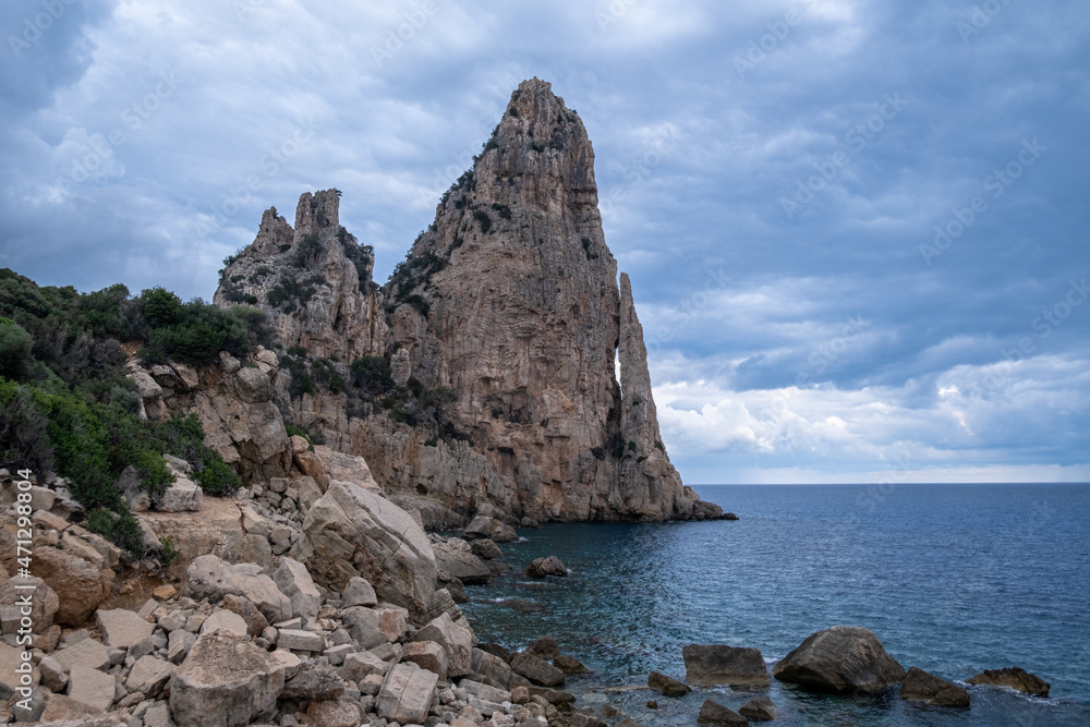 Pedra Longa in Sardinia Italy. Rocky shore by the ocean. Rocky beach during dusk. Pedra Longa in Sardinia Italy. Rocky shore by the ocean. Rocky beach during dusk.