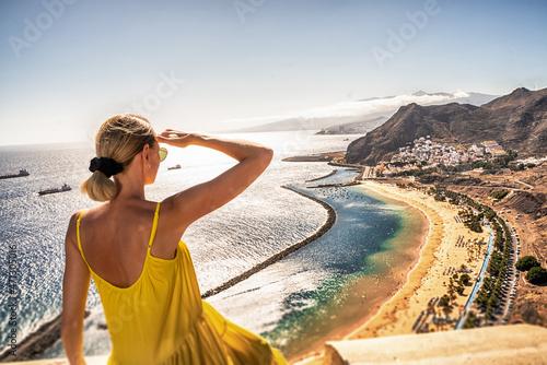 Amazing place to visit. Woman looking at the landscape of Las Teresitas beach and San Andres village, Tenerife, Canary Islands, Spain. photo