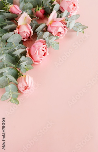 Flowers background.Pink roses  and eucalyptus branch bouquet frame top view o...