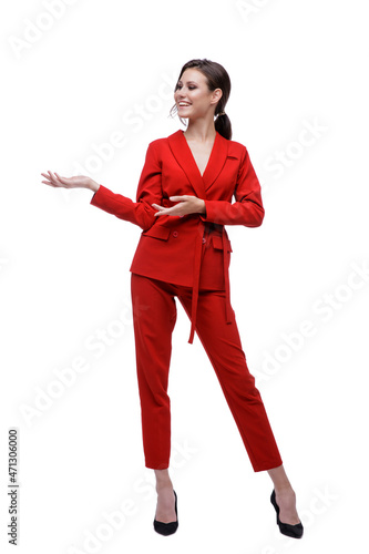 High fashion photo of a beautiful elegant young woman in a pretty red suit, jacket, pants, trousers posing over white background. Slim figure. Studio Shot. Businesswoman