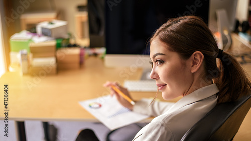 happy smiling businesswoman using smartphone for work and shopping onlone in office room photo