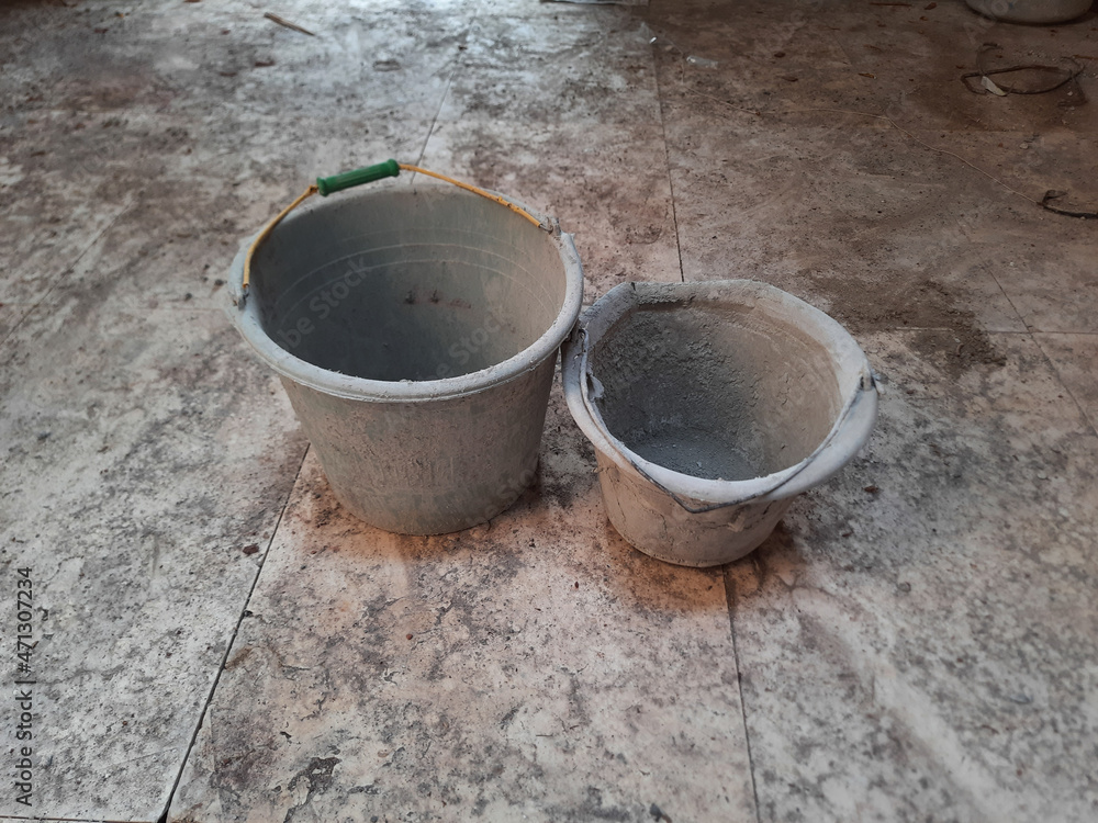 Used construction buckets, covered by dry cement. Buckets for mixed cement. Used construction buckets, covered by dry cement. Buckets for mixed cement.