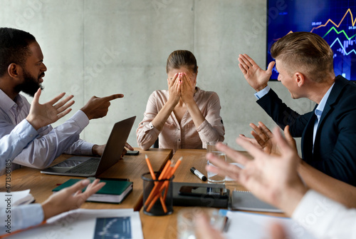 Stress At Workplace. Group Of Collagues Shouting At Female Employee In Office