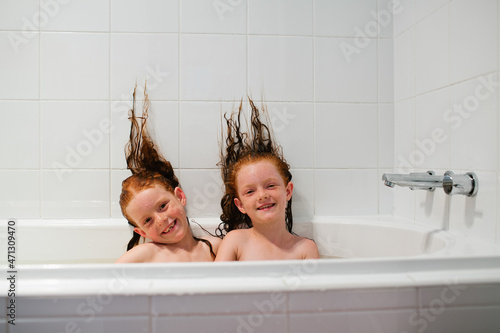 Two girls sitting in a bath photo