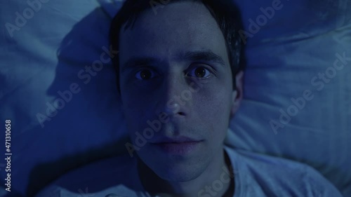 Sleeping man quickly opens his eyes