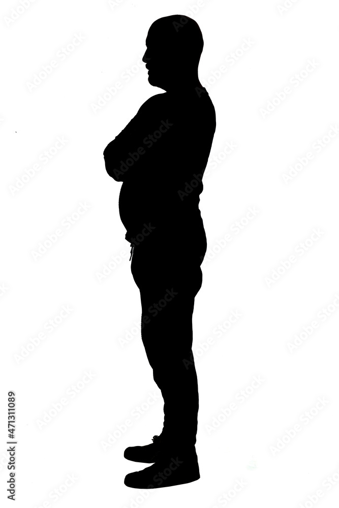 side view of the silhouette of a man wearing casual clothes with his arms crossed