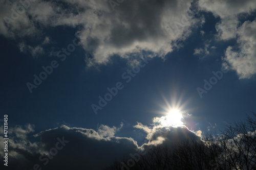 sun in the autumn sky is covered with clouds. Abstract background.