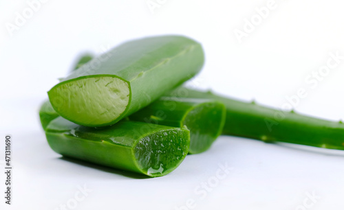 Close-up of organic green fresh aloe vera transparent gel in bowl, isolated over white, light passes through transparent gel, skincare product, Aloe vera cut into small pieces. photo