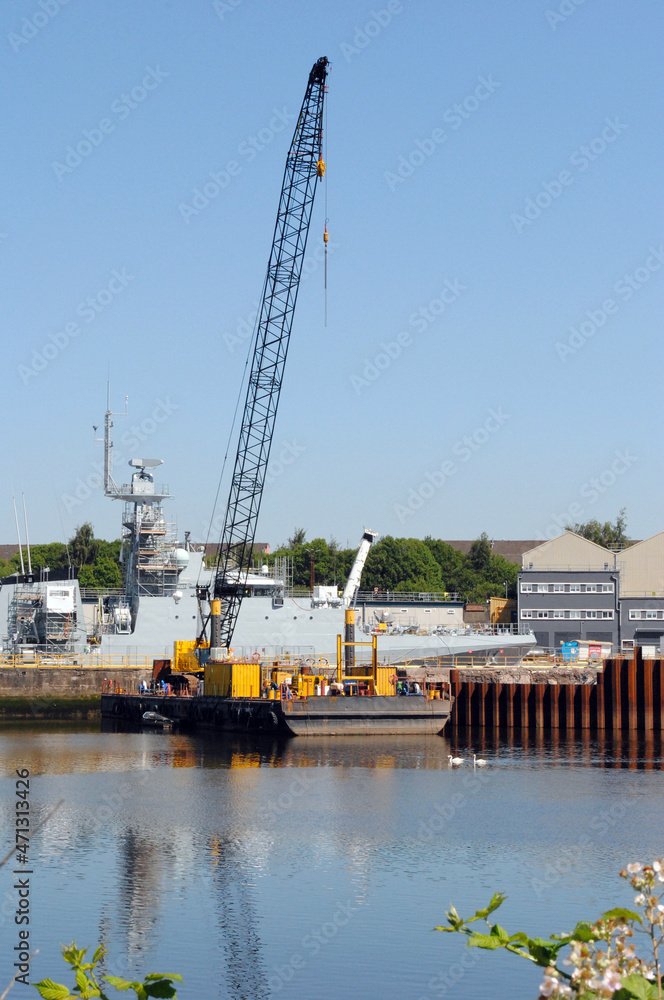 River View of Naval Ship & Industrial Crane against Blue Sky River View of Naval Ship & Industrial Crane against Blue Sky