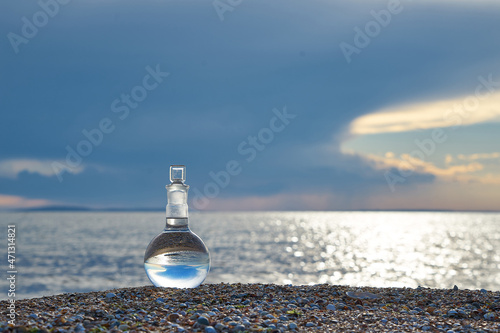 Glass flask by the sea.