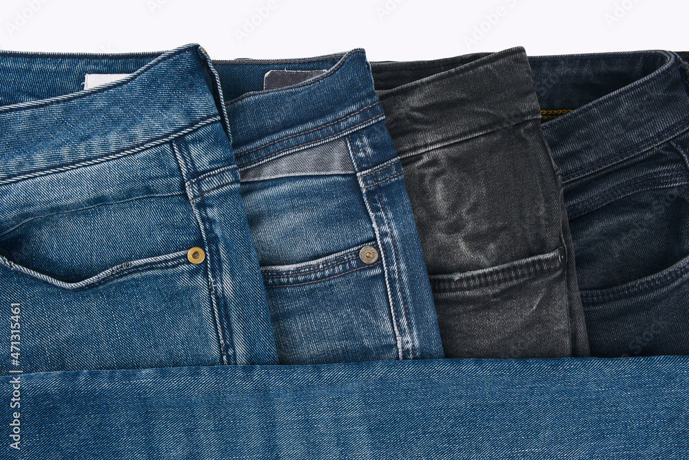 Stack of Various Shades Of Blue Jeans On White Background Denim jeans  texture. Denim background texture for design. Canvas denim texture. Blue  denim that can be used as background. Stock Photo
