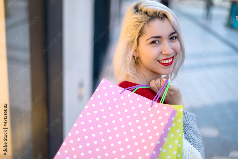 beautiful young blonde woman smiling with shopping bags outside beautiful young blonde woman smiling with shopping bags outside