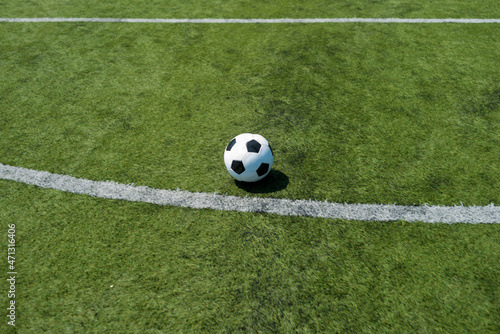A Traditional soccer ball on soccer field © 2Design